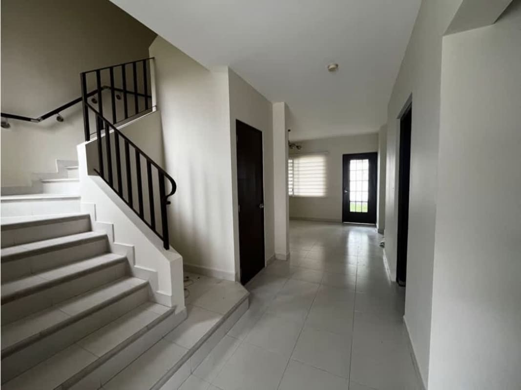 Spacious living room with staircase, ceiling fan, ceramic tile floors in Costa Sur Panama