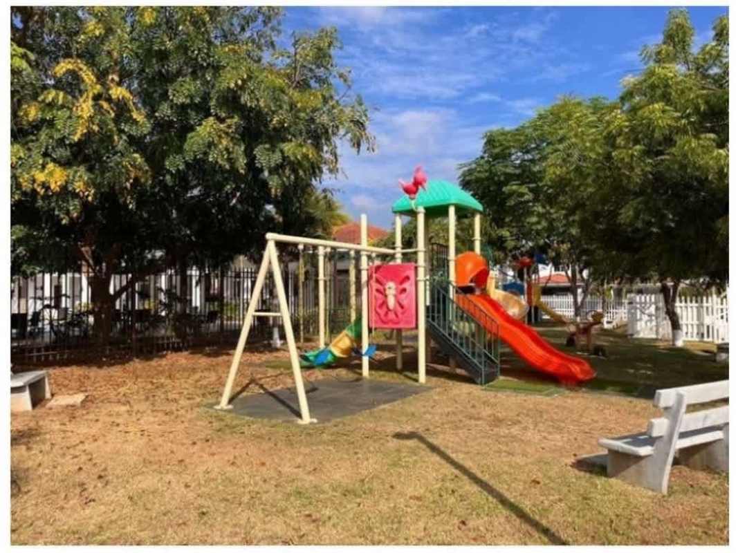 Two-story townhouse with tiled roof and carport in Quintas de Versalles Costa Sur Panama