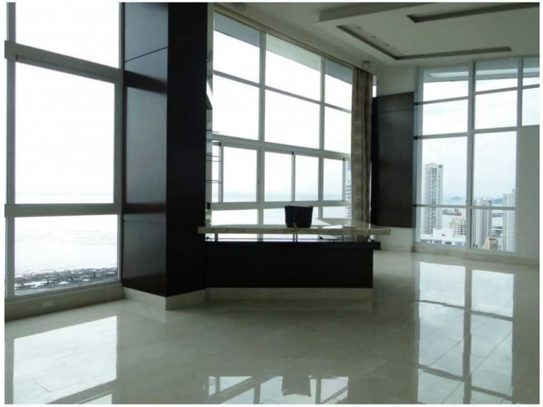 Floor-to-ceiling window view from penthouse with Pacific Ocean and city skyline