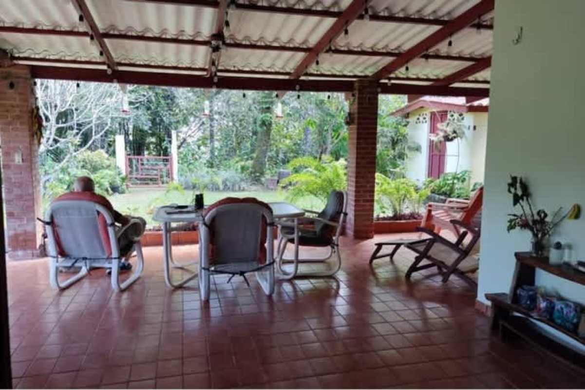 Covered patio with outdoor dining space and garden views in Cerro Azul Panama home