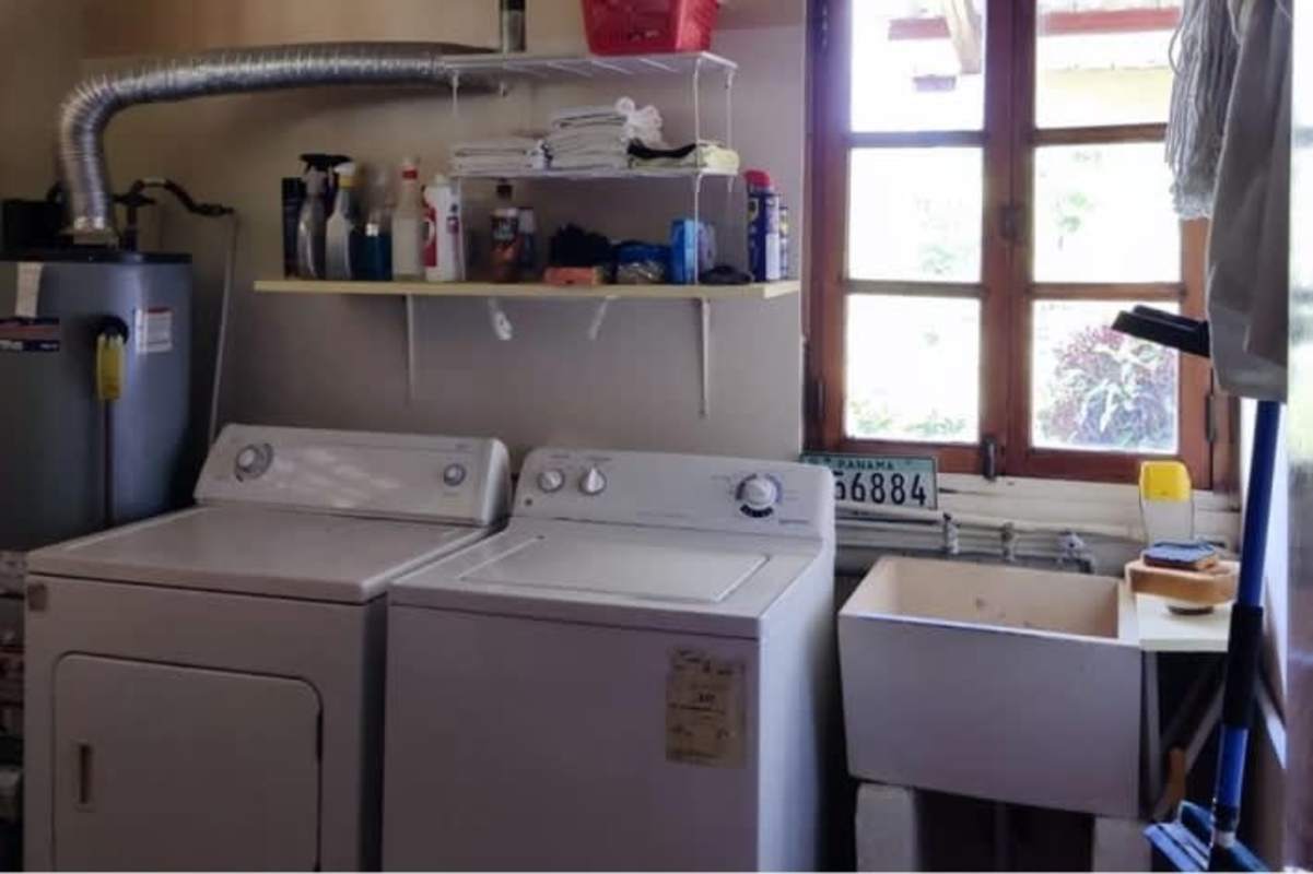 Granite kitchen counters with stainless appliances and wood cabinets in mountain home Cerro Azul Panama