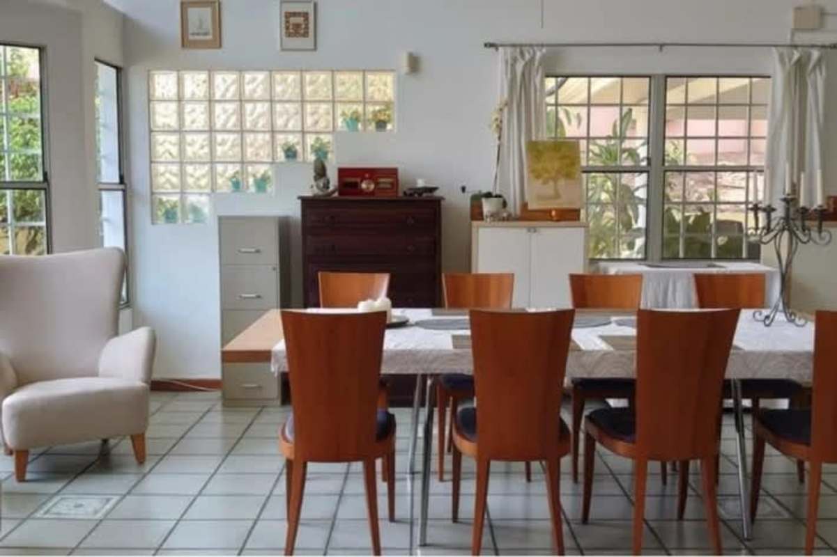 Kitchen with granite countertops and white cabinets in Club de Golf house