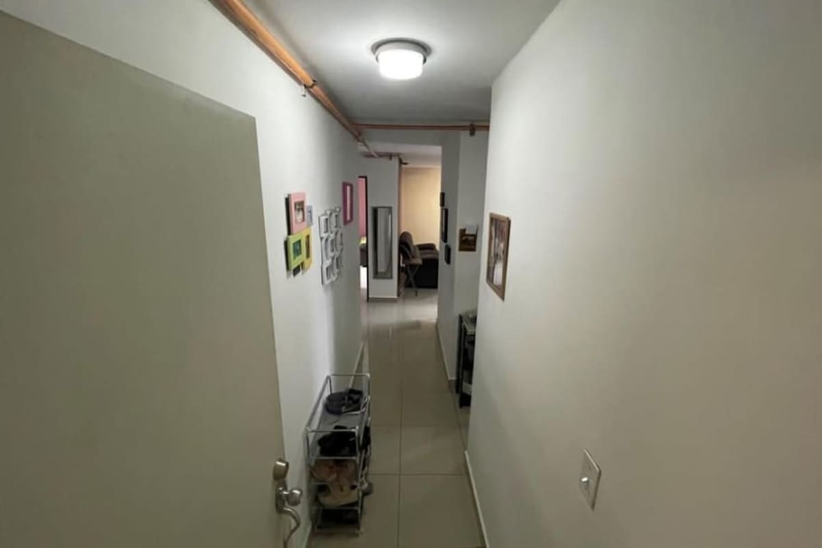 Hallway with white walls and tile floor inside apartment in PH Santa Elena Tower Panama City