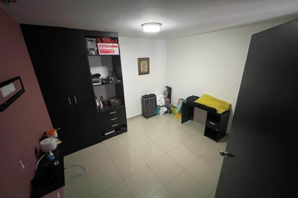 Small bedroom with built-in black wardrobe in Parque Lefevre apartment Panama