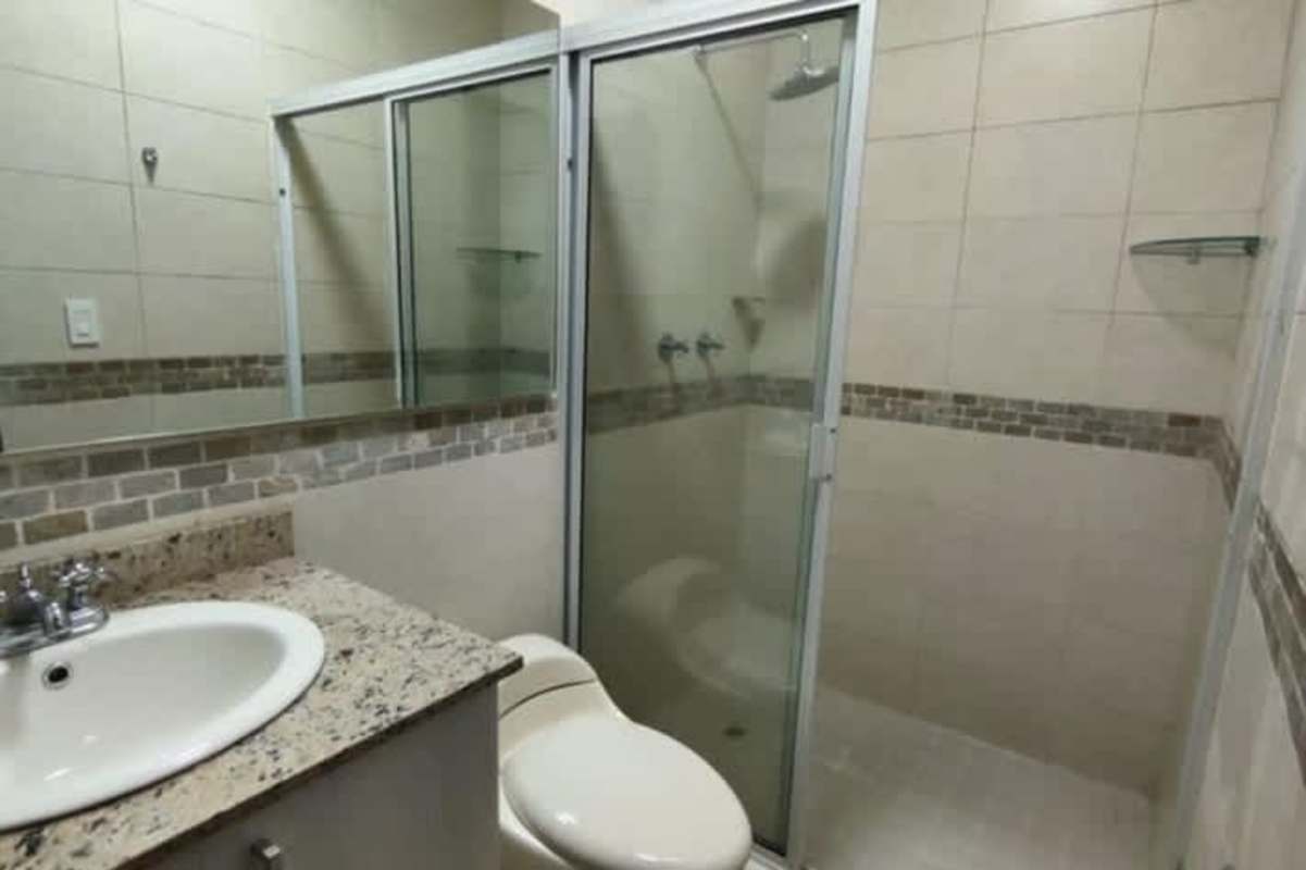 Spacious living room with marble floors and large windows in luxury PH Serenade apartment San Francisco Panama