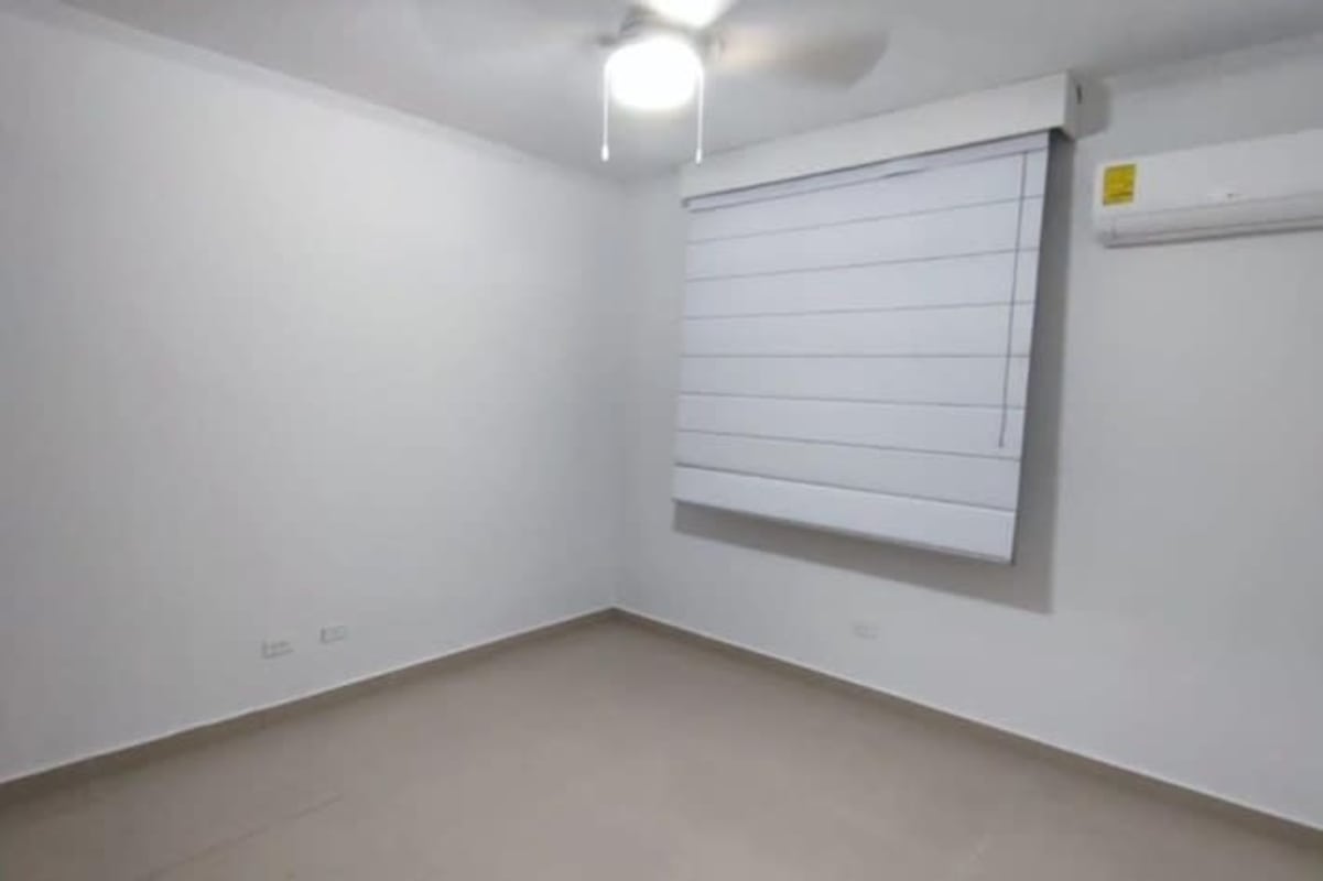 Modern double sink bathroom with marble counters and tiled walls in PH Serenade apartment Panama