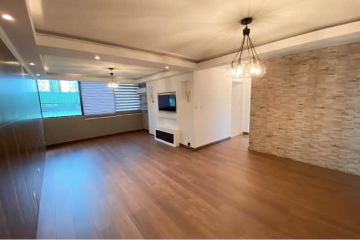 Remodeled kitchen with grey cabinets, built-in oven, gas cooktop, and washer area PH San Francisco Park Tower Panama