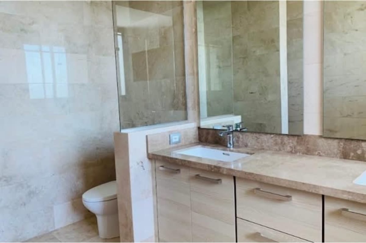 Modern bathroom with marble dual sinks and glass shower PH Ocean House