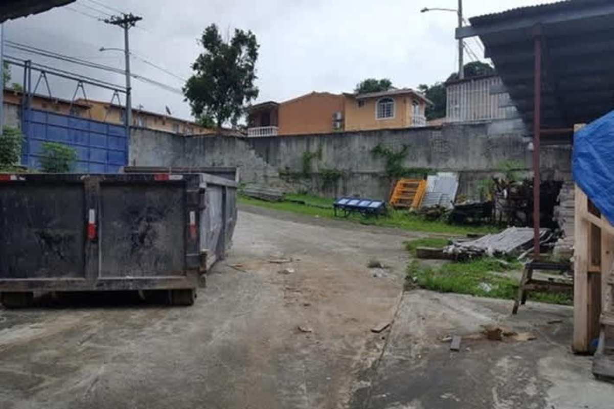 Interior storage warehouse with crates, glass panels and metal roof in Tocumen
