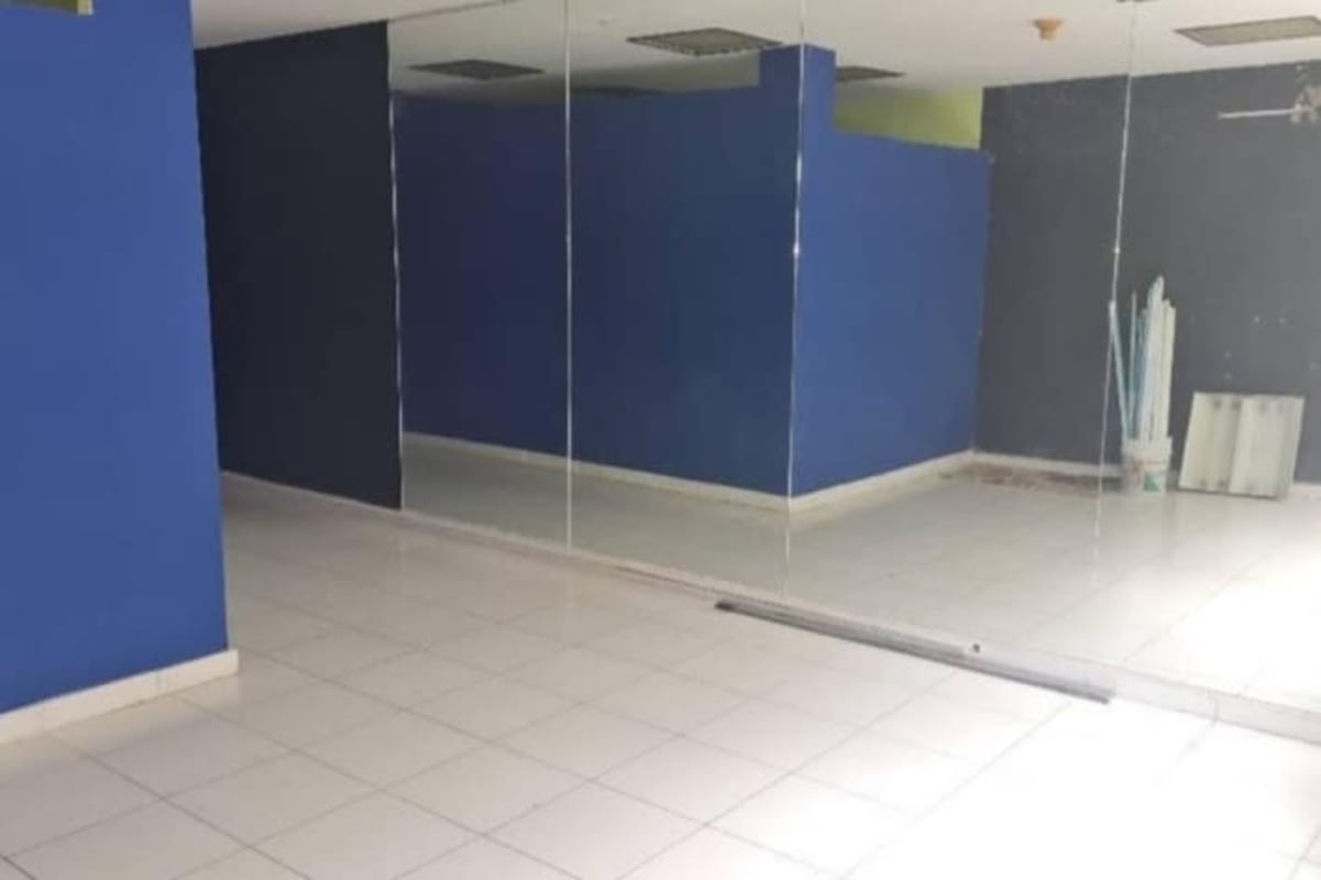Empty commercial studio with large wall mirrors and white tiled floor El Cangrejo Panama