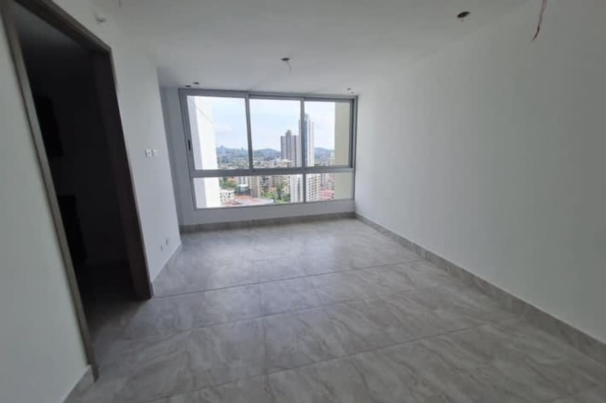 Modern living room with panoramic windows offering city skyline view at PH El Cangrejo Plaza Panama