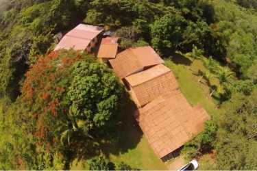 Aerial image shows rural compound with red tile roofs amid tropical greenery La Chorrera Panama