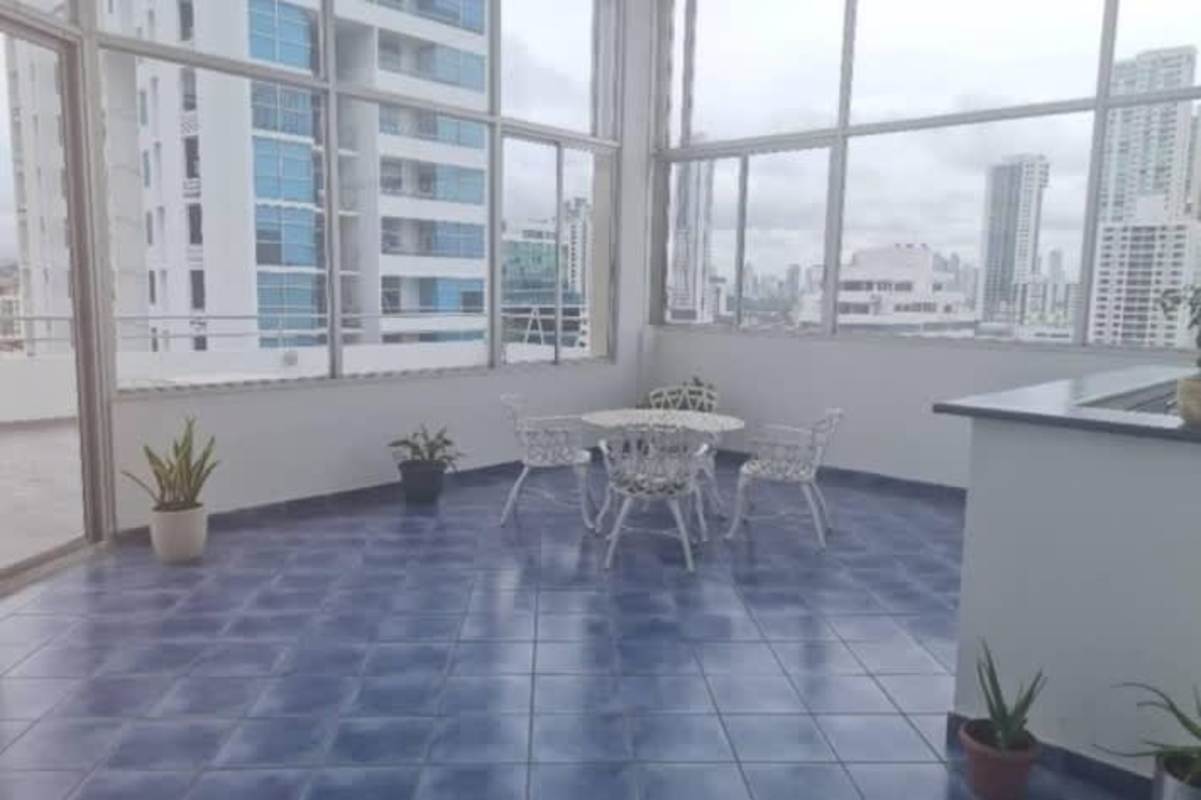 Enclosed balcony with blue tile floor and large windows, city skyline views, PH San Francisco Bay Panama
