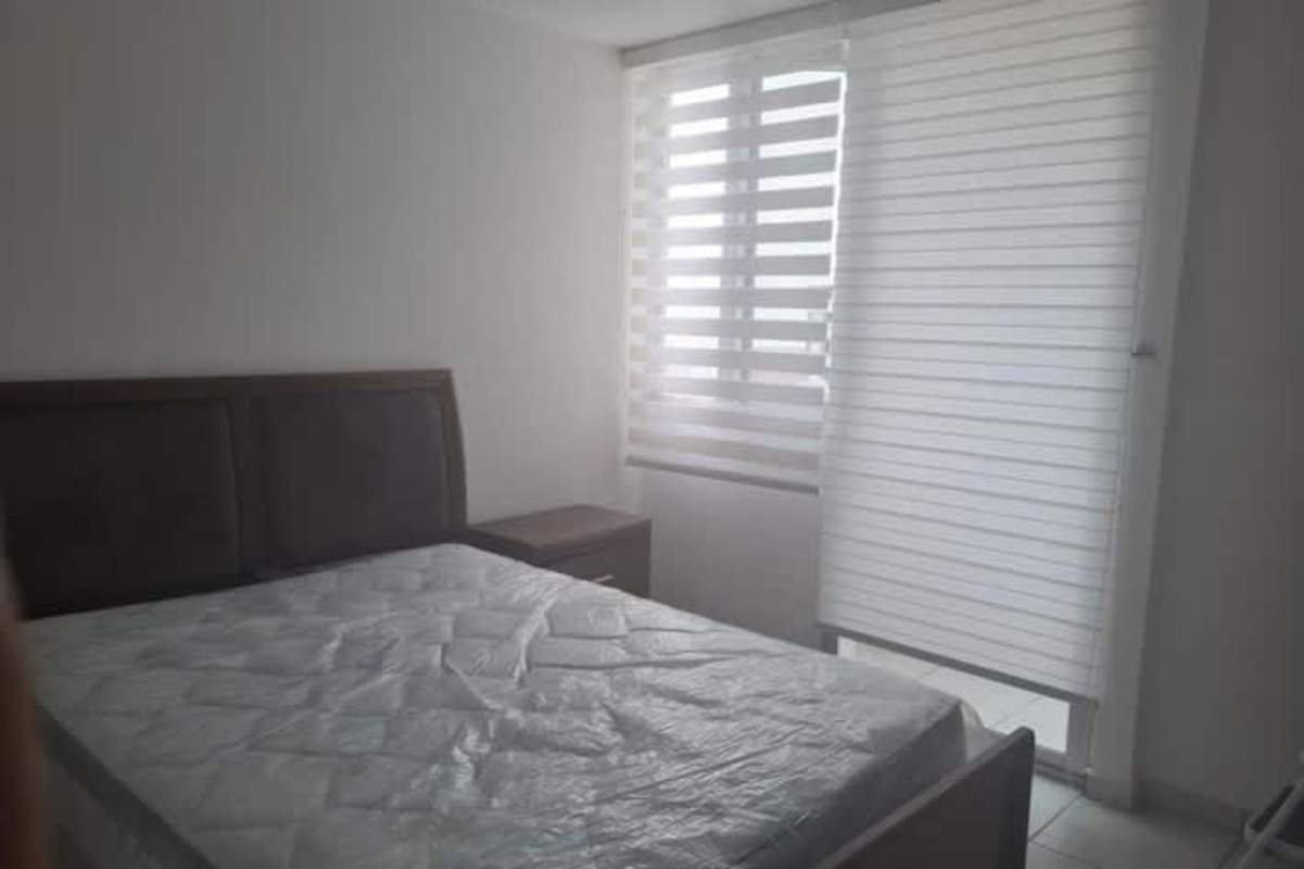 Minimalist bright bedroom with large window and striped blinds in PH San Francisco Bay Panama City