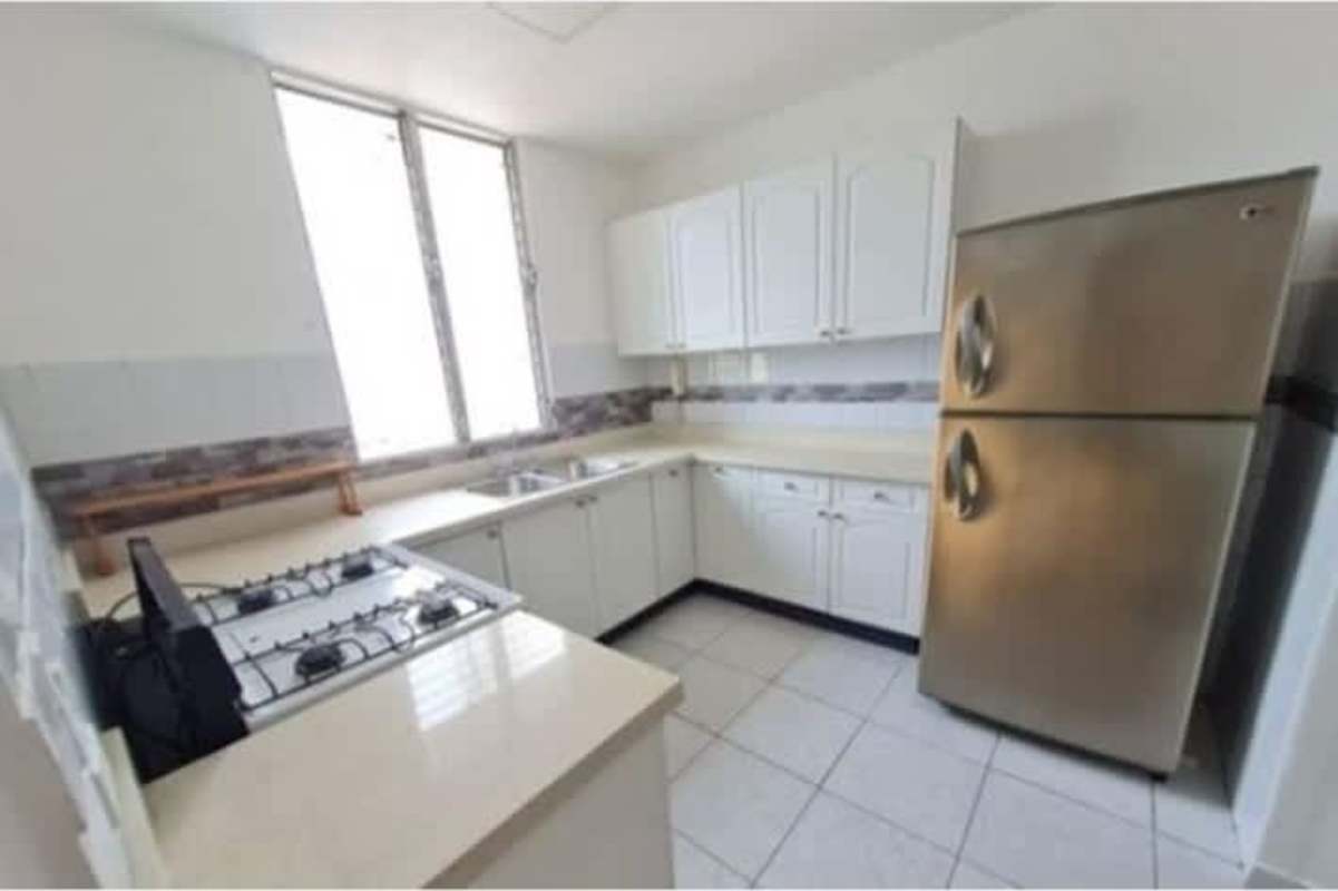 Spacious modern bedroom with large window, built-in wardrobe and tile floor in PH San Francisco Bay Panama