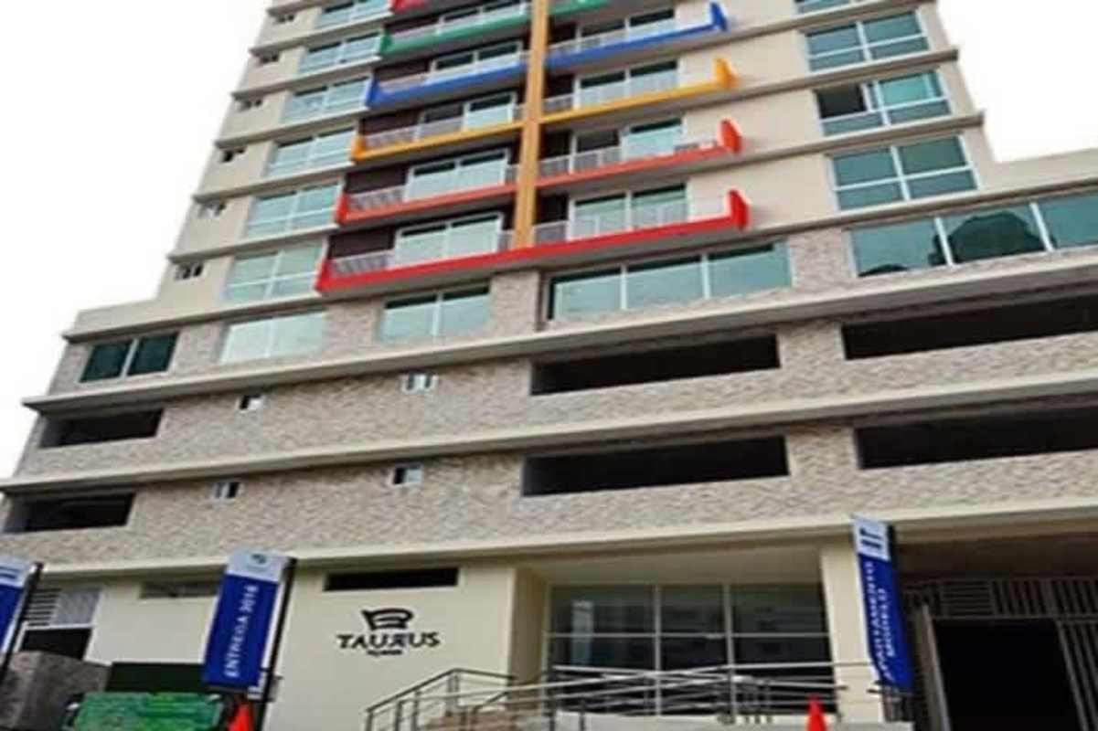 Apartment kitchen with granite countertops, tile backsplash, dark cabinets in PH Taurus Tower in San Francisco Panama