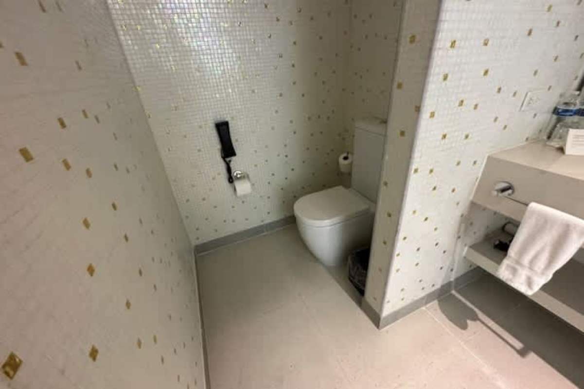 Modern workspace lounge area with floating desk and TV in Golden Tower hotel suite Panama City