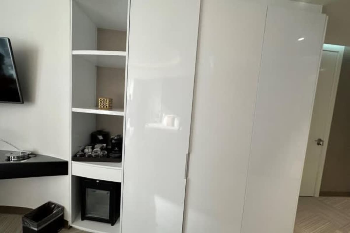 Luxury hotel bathroom with vessel sink, glass shower and mosaic tiles inside Golden Tower Punta Paitilla