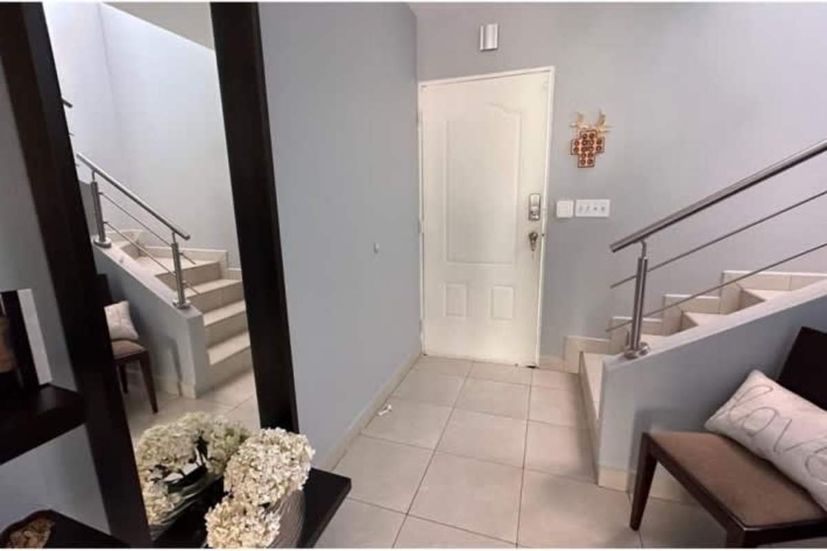 Bright living area with tiled floors and large windows at Villa Tivoli duplex Panama