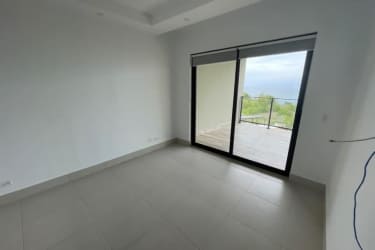 Bedroom with balcony access and ocean view inside Punta Caelo Solaria Panama