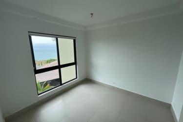 Modern bedroom with ocean view window at PH Solaria Punta Caelo Panama