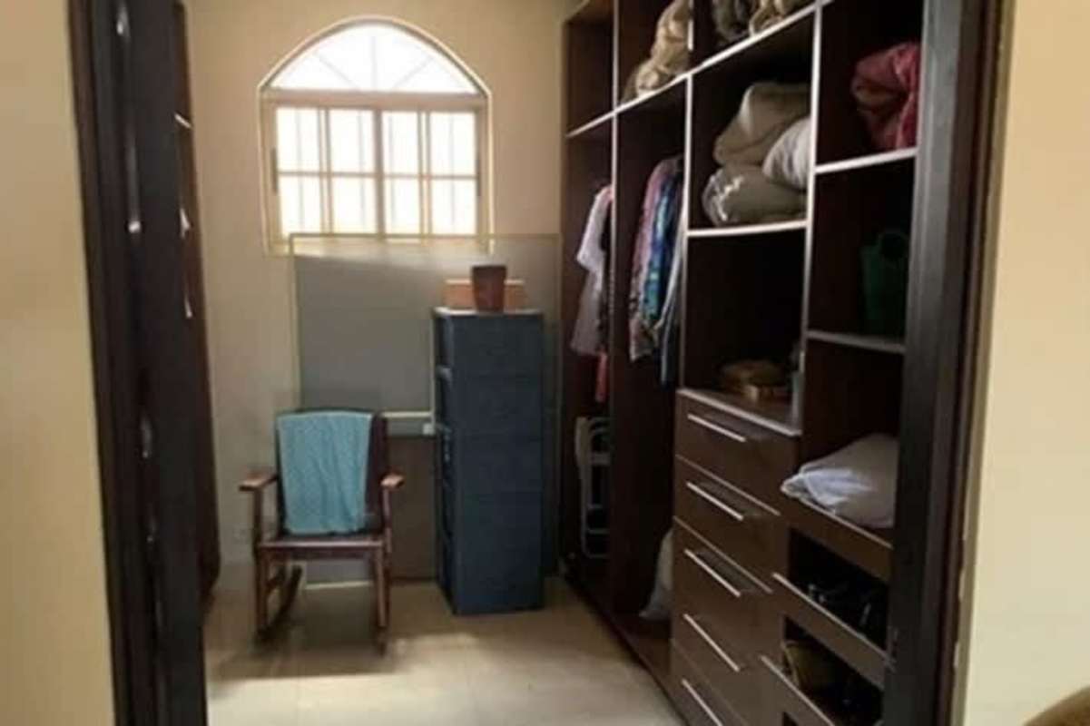 Traditional dining room with chandelier, large window, marble floors in home Chanis Panama City