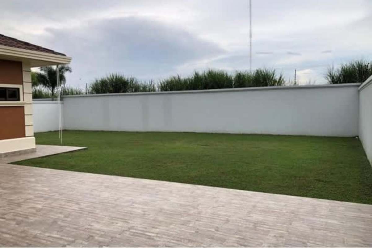 Luxury kitchen with center island, dark cabinets, stainless steel fridge and appliances in Costa Sur house