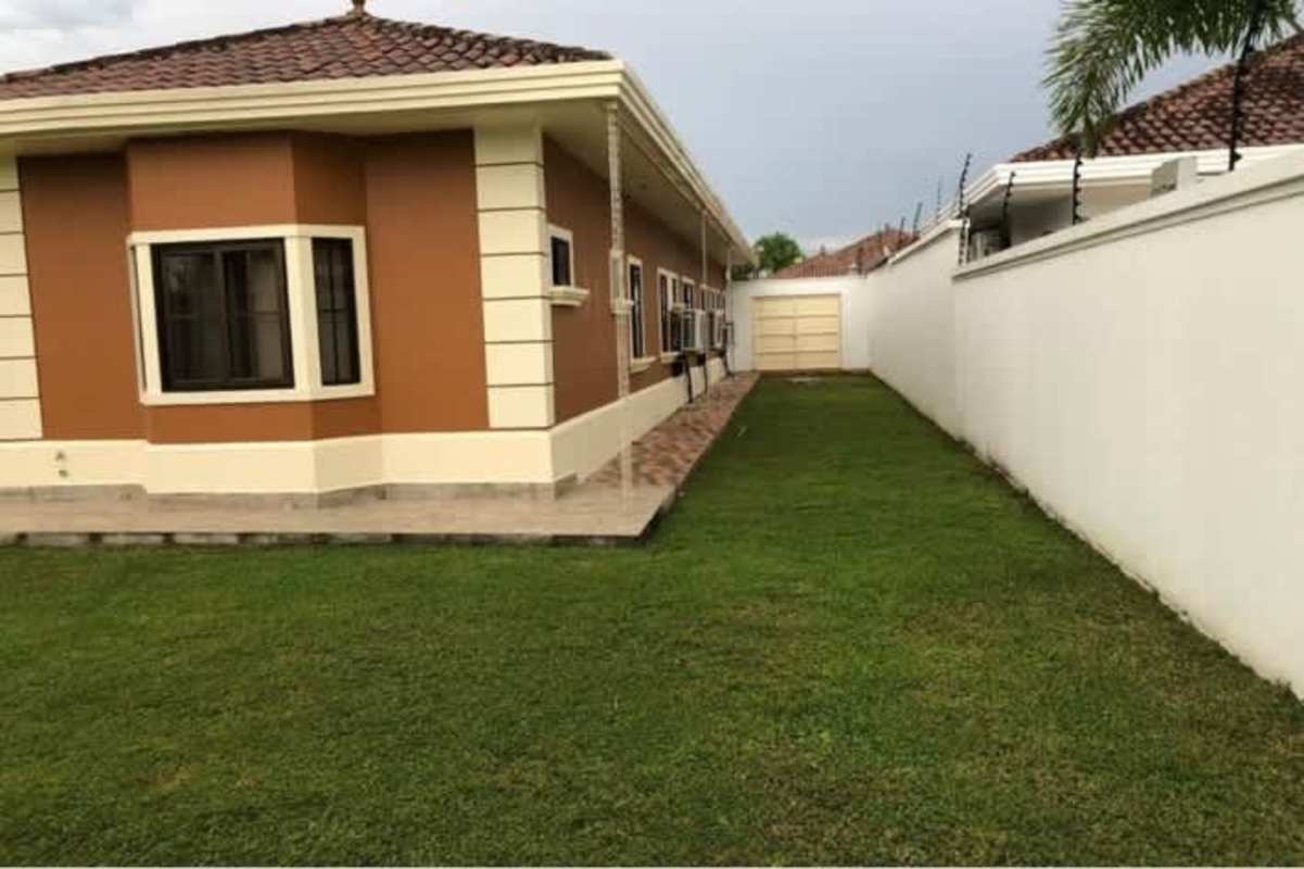 Spacious living room with marble floors, large glass doors, recessed lighting in Sunset Coast home Panama City