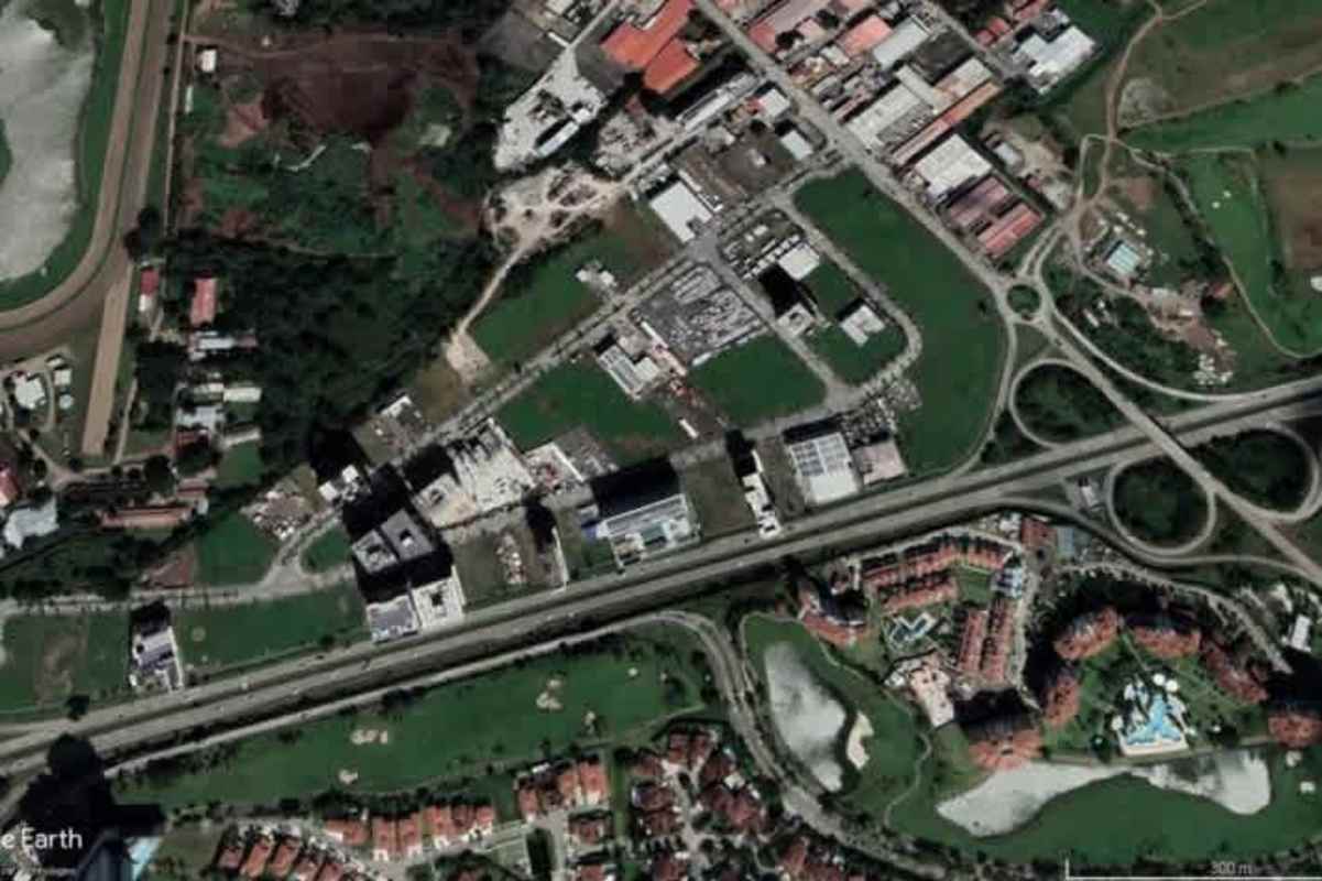 Aerial photo of industrial park with palm trees, warehouses, parking areas and mountain backdrop in Santa Maria Panama