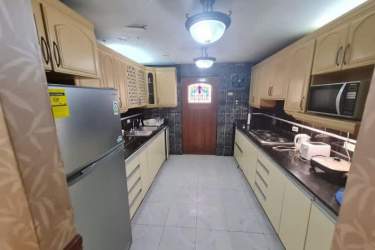 Traditional living room with elegant furniture, lighting, and tiled floors in Barrio Norte house