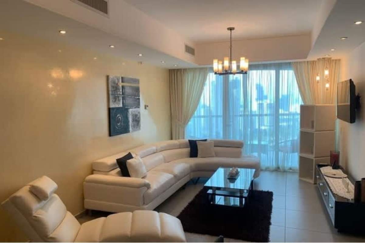 Contemporary living room with floor-to-ceiling glass, balcony and ocean views in PH BICSA Panama City