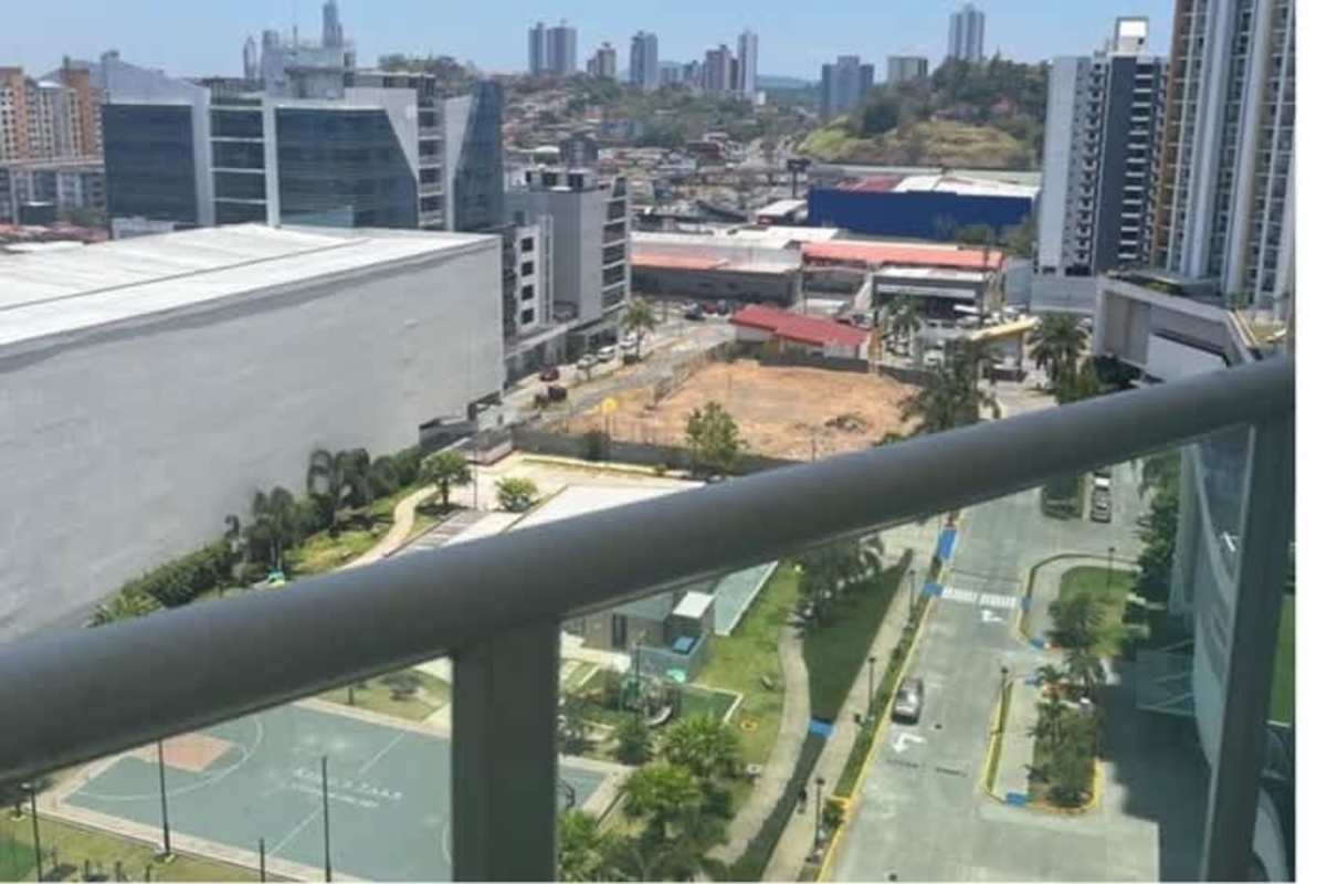 High-rise balcony view with basketball court, gardens and city skyscrapers at PH Kings Park Condado del Rey