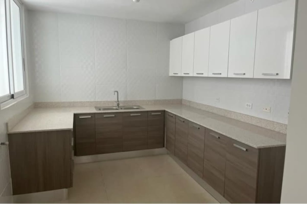 Elegant bathroom with beige tiled walls, glass shower enclosure and modern fixtures in PH Kings Park Condado del Rey