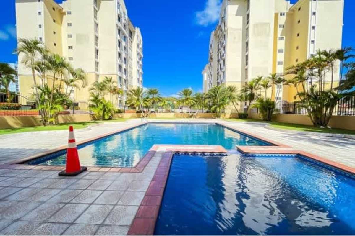 Outdoor pool landscaped social space and tower view PH McGregor Hill Condado del Rey Panama