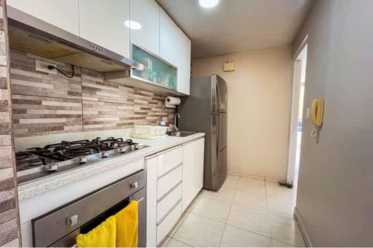 Compact updated kitchen with laundry space tile backsplash cabinetry in PH McGregor Hill