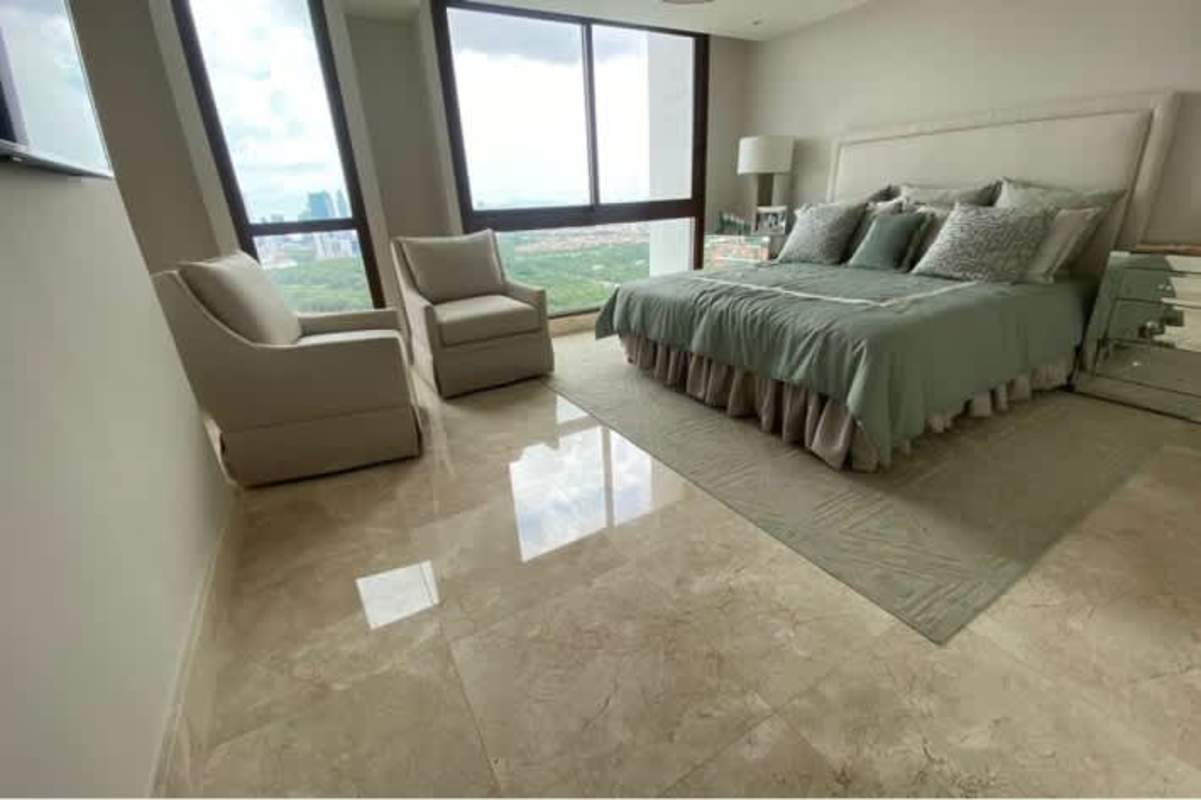 Spacious primary bedroom, panoramic windows, city and golf views at Santa María condo