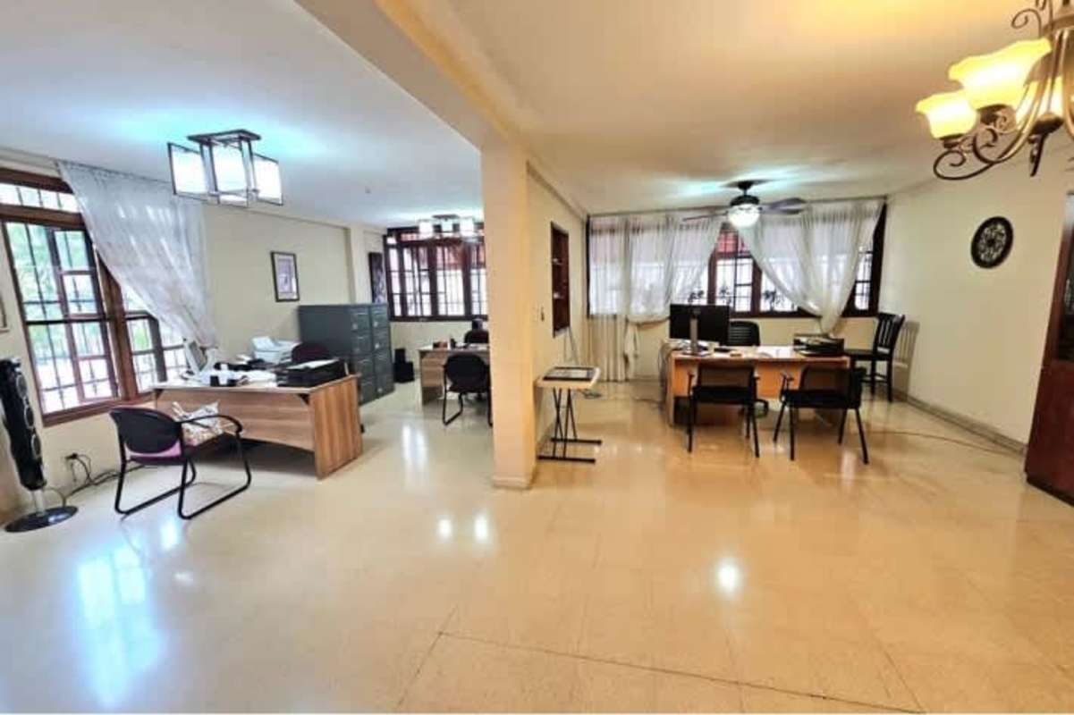 Spacious office space with large windows and neutral decor in duplex home San Francisco Panama