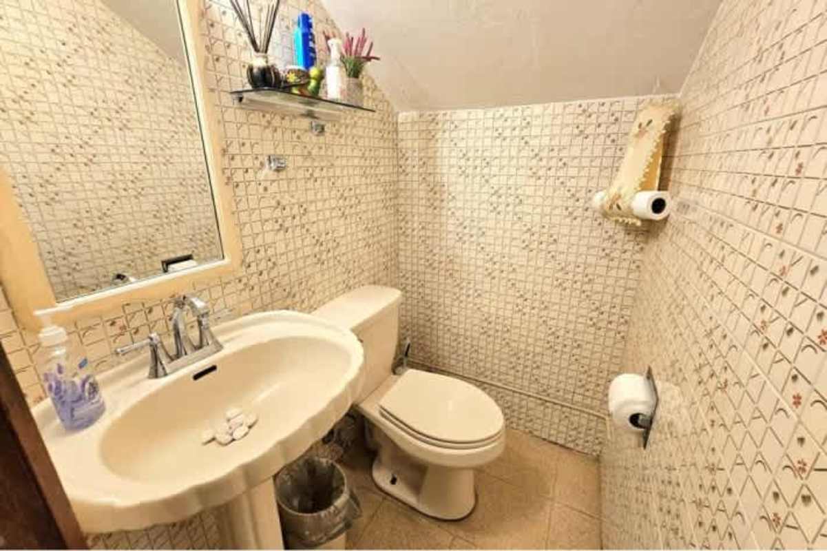 Living space with tiled floors and staircase in duplex home San Francisco Panama