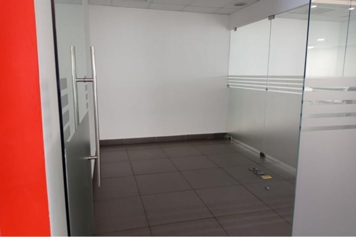 Partitioned private office suites with frosted glass walls in Oceania Business Plaza Panama City