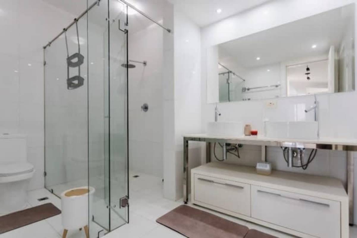 Spacious living room with panoramic windows city skyline view at Yoo Panama