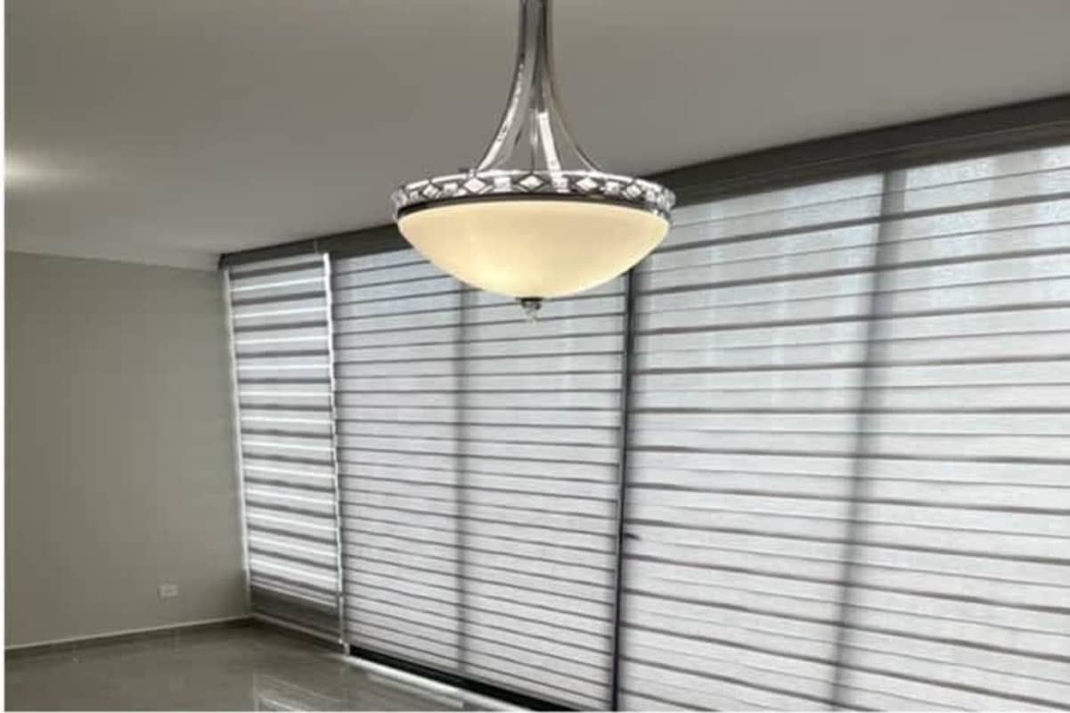 Kitchen with granite countertops, white cabinets, double sink in Costa del Este apartment