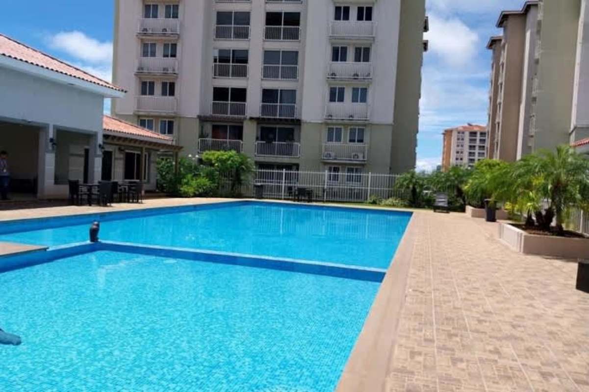 Swimming pool with fenced patio and apartment buildings PH Versalles Panama City