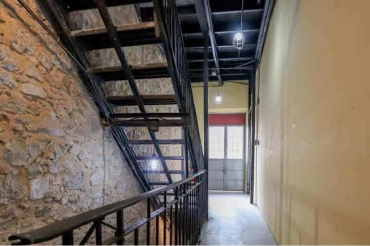 Metal staircase interior with exposed stone walls Casco Viejo Panama