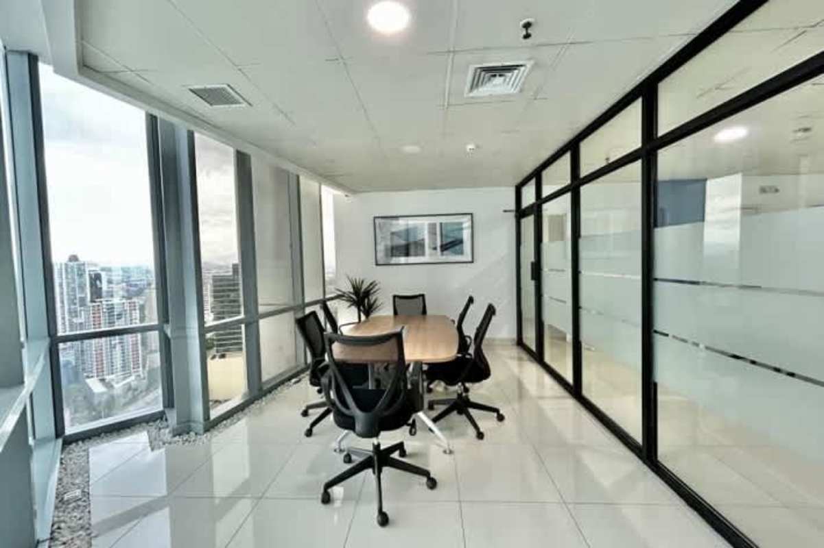 Modern open workspace with furnishings and glass walls inside PH Costanera Costa del Este