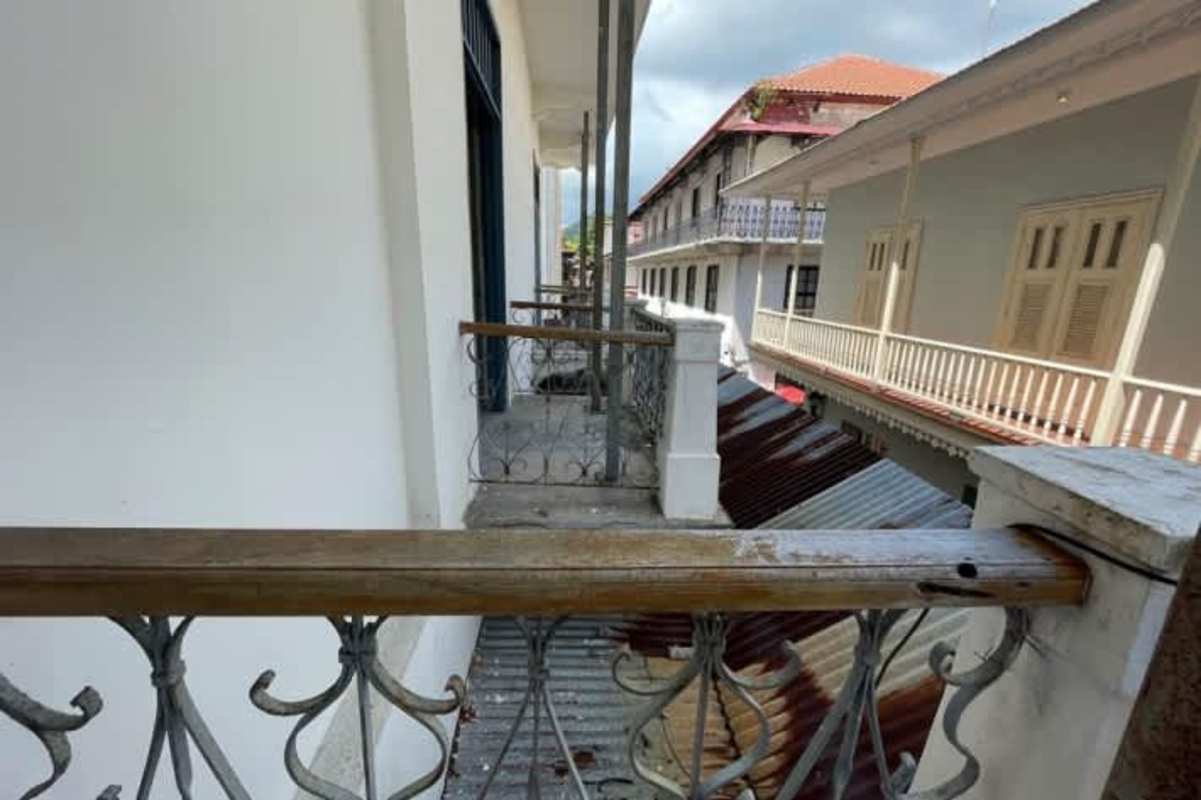 Narrow colonial balcony with decorative railing overlooking historic Casco Viejo street Panama
