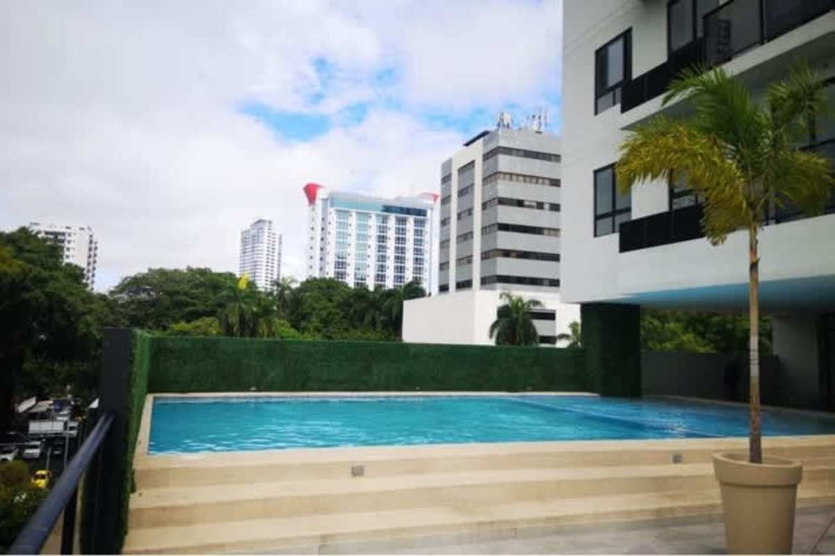 Outdoor swimming pool with sunbathing terrace at PH The Gray, panoramic city views in Calle 50