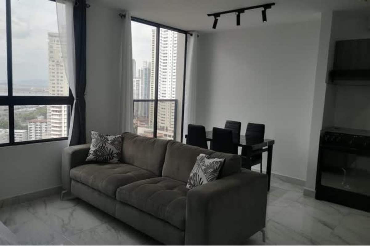 Modern living dining area in furnished apartment at PH The Gray with city skyline backdrop