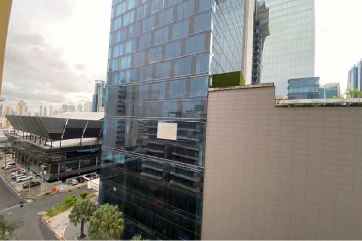 Laundry area with appliances, cabinets, and utility sink in Obarrio Panama apartment