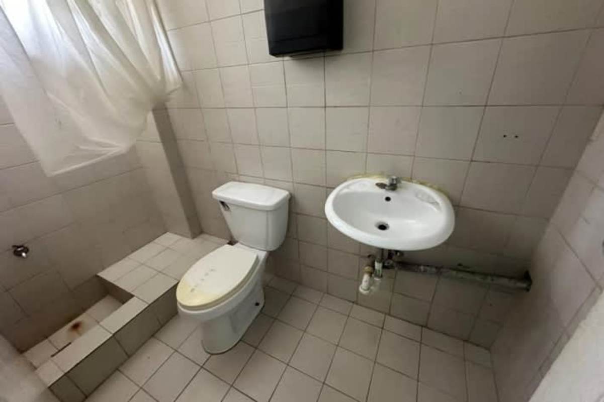 Empty Panama commercial property interior featuring tiled floors, accent color stripes, drop ceiling lighting