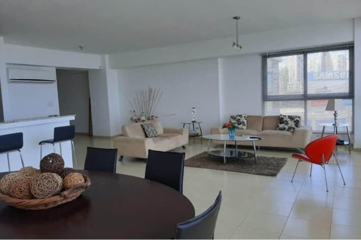 Living room with large windows, balcony access, ocean and city views in PH Grand Bay Tower Avenida Balboa Panama City